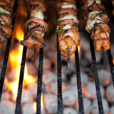 Barbequiing pork and vegeytable kebabs